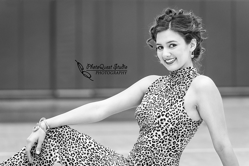 High School Senior photos session of beautiful Latina Teen from Menifee, California - Miss Isabel Donadio.  Location: Paloma Valley High School, Menifee, CA.  Photography: PhotoQuest Studio - Menifee Wedding, Family and Event Photographer, Isabel sitting on the gym basketball floor
