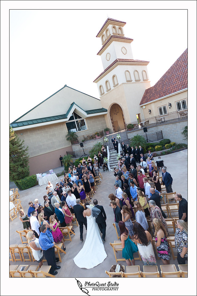 South Coast Winery Wedding Photography by Temecula, Menifee, Murrieta Wedding Photographer. Bride enter the ceremony with her Fathers