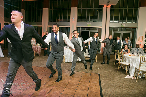 men running at mexican wedding reception