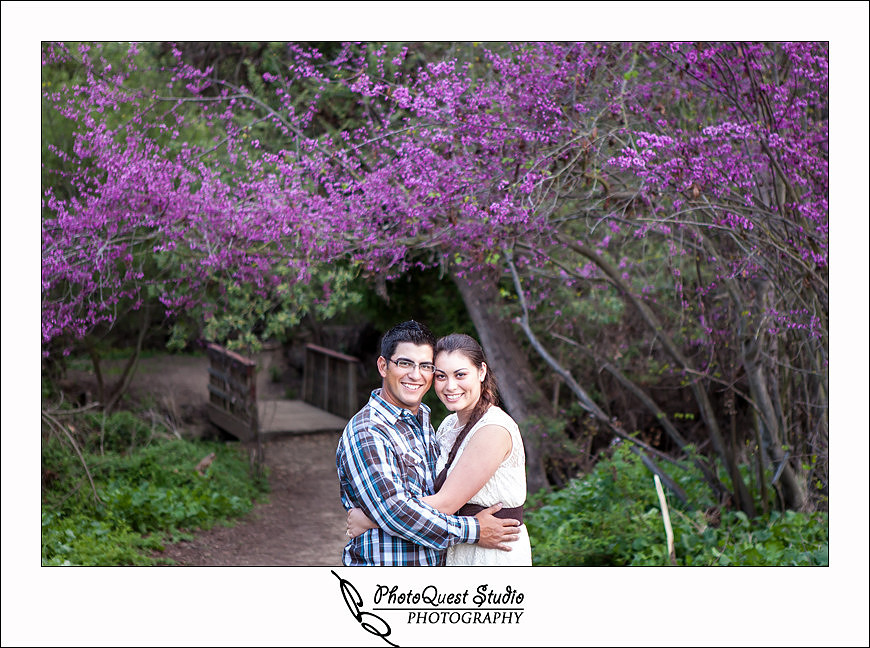 Romantic Temecula Old Town and Fallbrook Sunset Engagement Photo Session by Menifee, Temecula Wedding Photographer - Future Bride and Groom in front of beautiful flowers