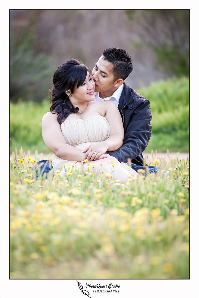 Romantic Temecula Old Town and Fallbrook Engagement Photo Session by Menifee, Temecula Wedding Photographer - David kissing Susan while sitting on a bed of flowers