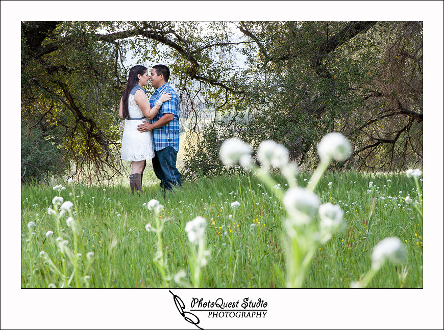 Valley Center Mountain Top Engagement Photo Session by Menifee wedding photographer, Murrieta wedding photographer, Temecula Wedding Photographer, Valley center wedding photographer - Jessica and Lee kissing on the white flowers field