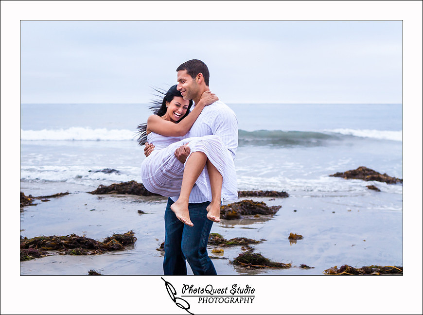 Oceanside engagement photo by temecula wedding photographer of photoquest studio photography at swami beach, playful time on the sand
