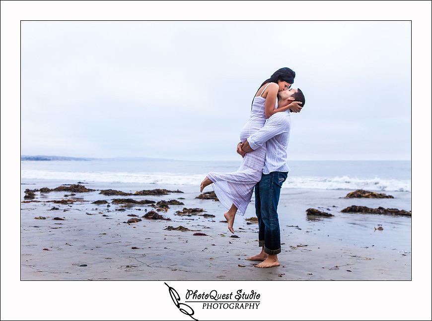 Oceanside engagement photo by temecula wedding photographer of photoquest studio photography at swami beach, pick her up and kiss