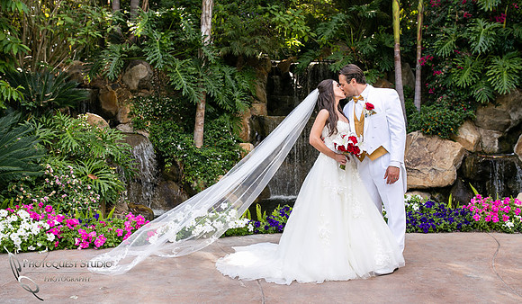 Kissing with flying veil at Grand Tradition Estate Fallbrook by Temecula Wedding Photographer