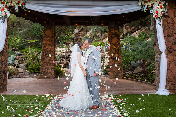kissing and flying petals at pala mesa resort wedding