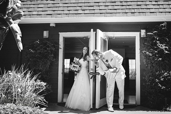 groom kiss the bride hand behind the door