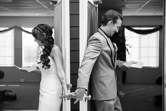 Wedding-photos-at-Grand-Tradition-Estate-Fallbrook-Bride-and-groom-holding-hand-and-read-each-letter