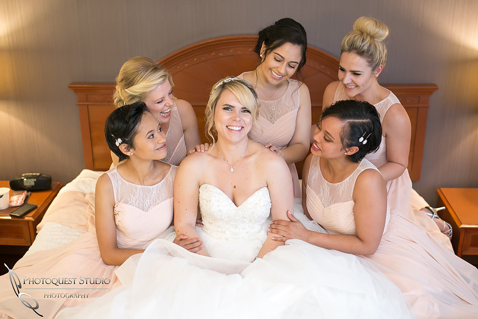 Bride and Bridesmaids having fun on the bed by Temecula, Fallbrook wedding photographer