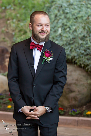 Groom watching his bride enter wedding ceremony