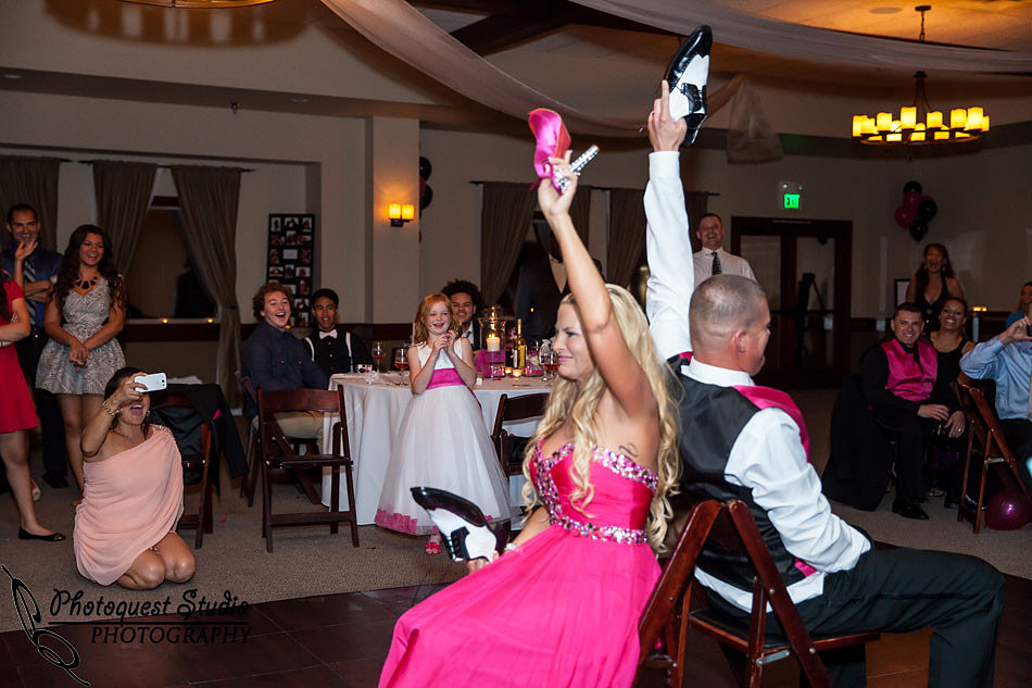 bride and groom having fun playing the shoes game at Wiens family cellars temecula winery by temcula wedding photographer