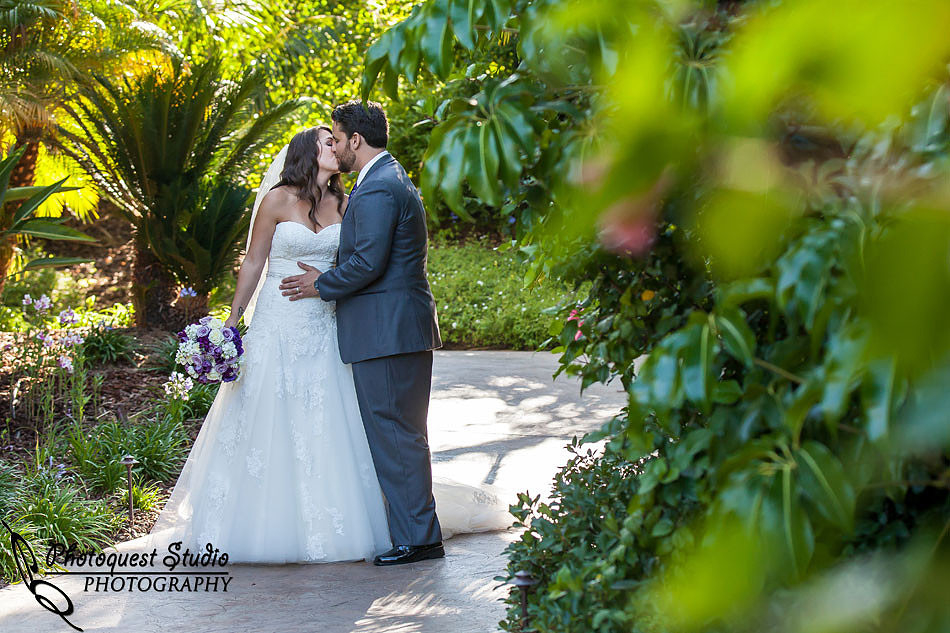bride and groom kissing in the garden
