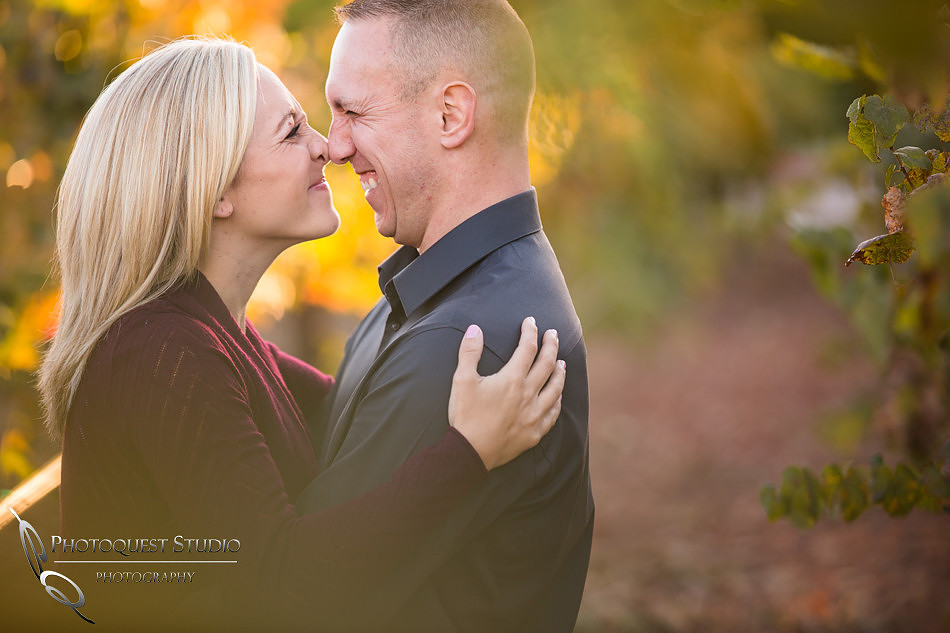 Playful moment at the vineyard at Engagement photo at South Coast Winery, California by Temecula Wedding Photographers