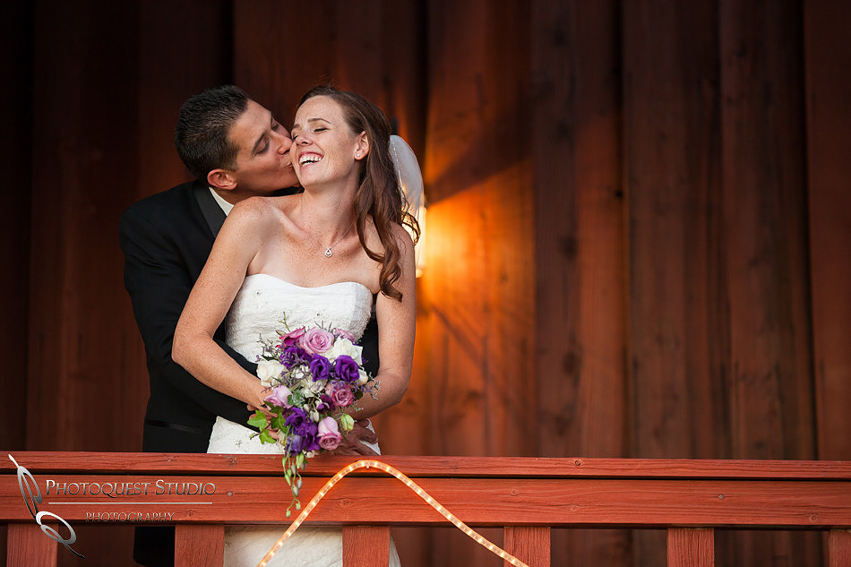 the groom lovely kiss at Falkner winery wine wedding by temecula wedding photographer