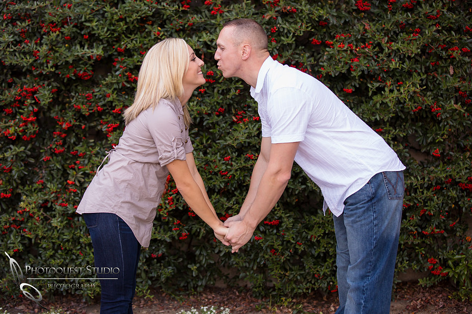 A muahzzz moment with a kiss at Engagement photo at South Coast Winery, California by Temecula Wedding Photographers