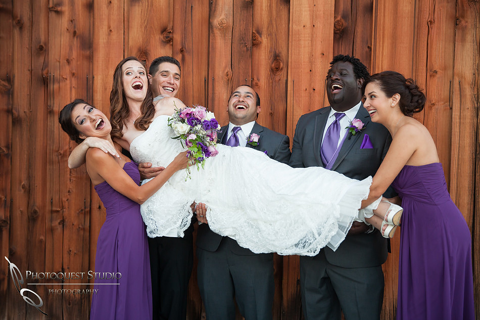 groom and bridal party holding the beautiful bride at Falkner winery wine wedding by temecula wedding photographer