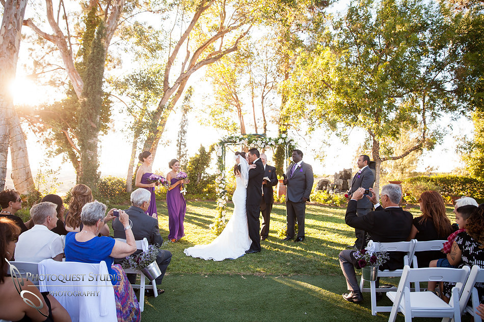 bride and groom first kiss at Falkner winery wine wedding by temecula wedding photographer